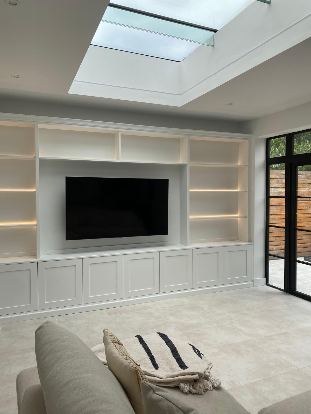 Modern built in furniture in Essex. Bespoke fitted media unit with shelving. Custom fitted storage solutions. 